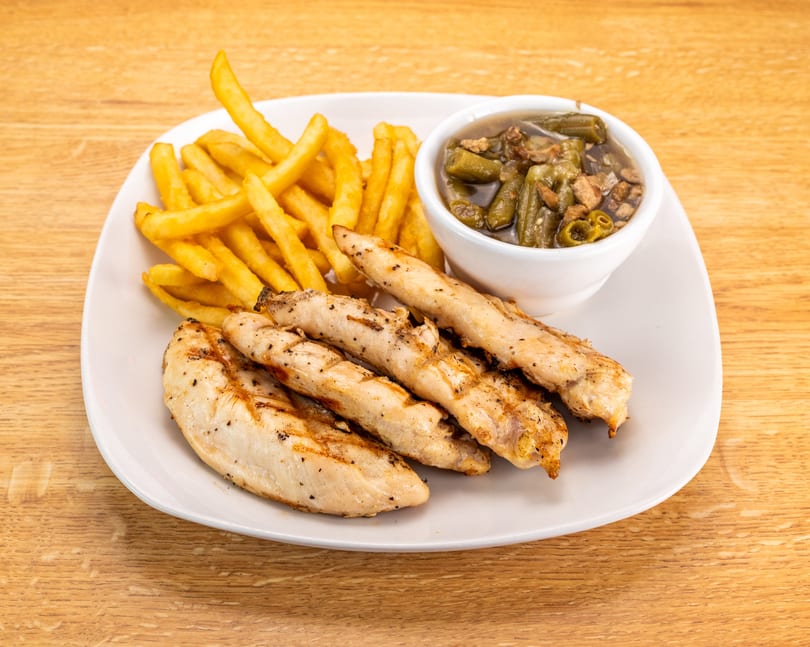Grilled chicken tenders, golden french fries, and a side of stewed okra on a white plate.